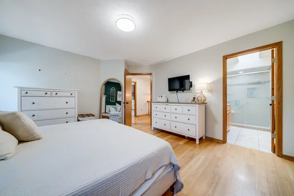 a bedroom with a bed and a flat tv screen in it