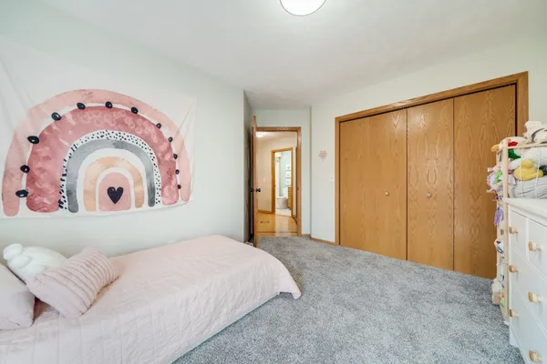 a bedroom with a bed and a couch