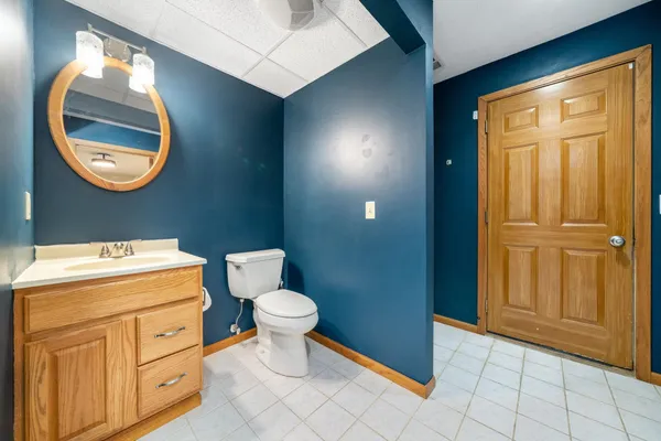 a bathroom with a toilet a sink and a mirror