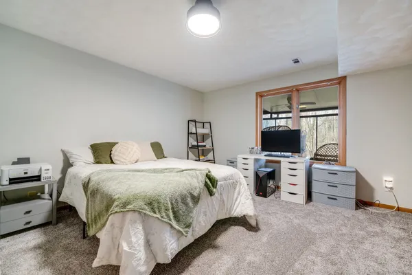 a bedroom with a bed and flat screen tv