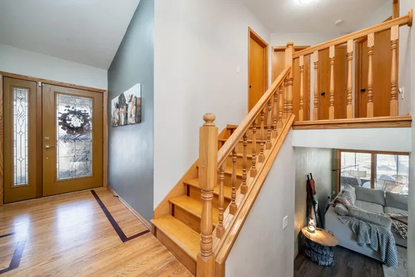 a living room with furniture and stairs