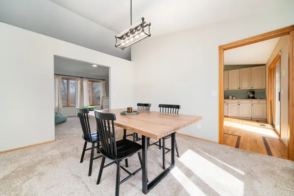 a view of a dining room with furniture and a chandelier