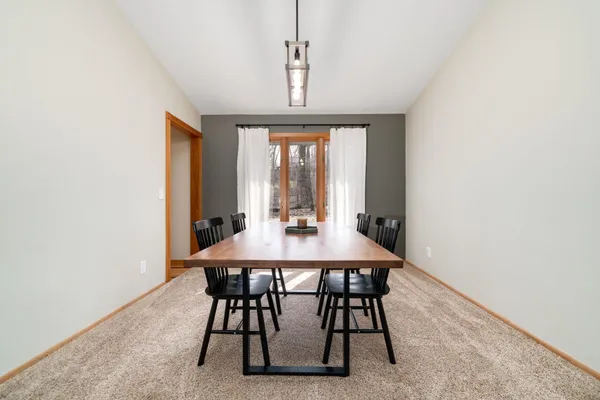 a view of a dining room with furniture window and outside view