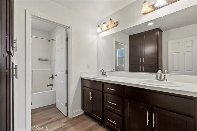 a bathroom with a double vanity sink and mirror