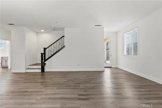 a view of an entryway with wooden floor