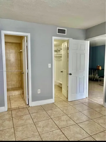 a view of a hallway with wooden shelves