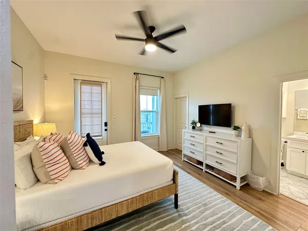 a bedroom with a bed and a flat screen tv