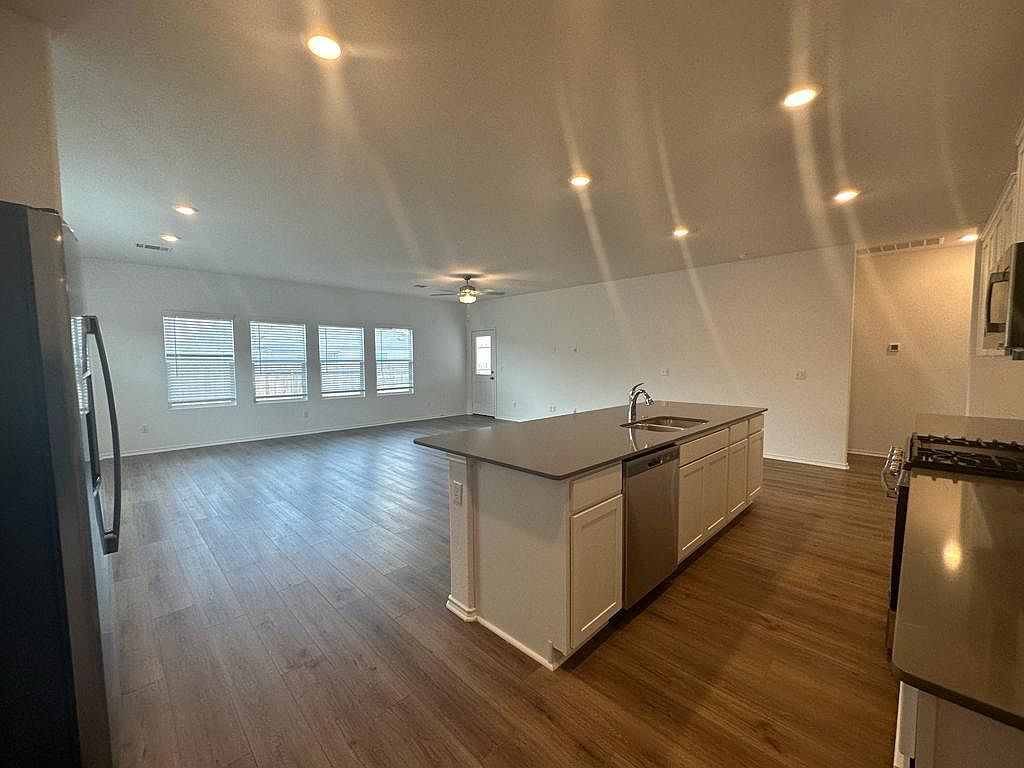 160 River Rise Road Kyle, TX 78640 - Photo 24 of 35 Open-concept living space featuring wood-finish flooring and recessed lighting