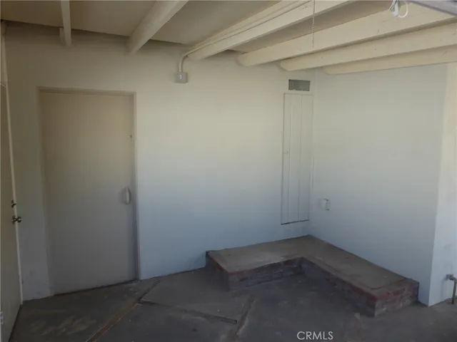 a view of an empty room and a window