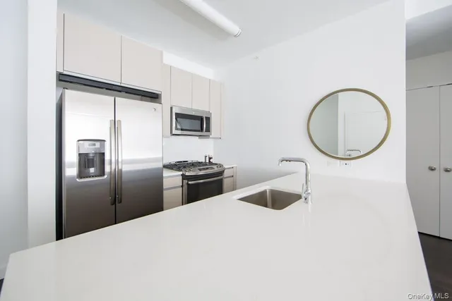 a kitchen with stainless steel appliances granite countertop a refrigerator sink and stove