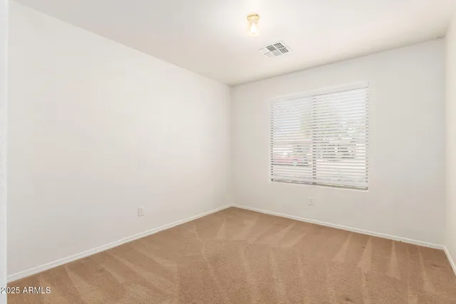 an empty room with closet area