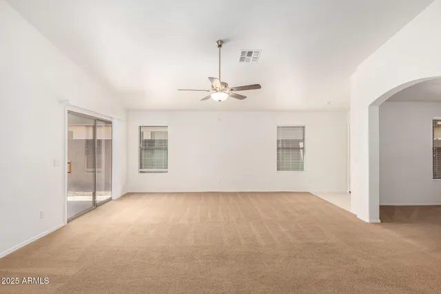 a view of an empty room with a kitchen