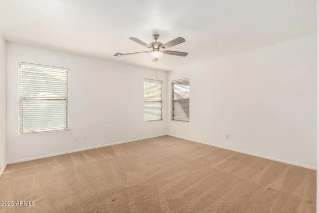 a view of a room with a ceiling fan and a window