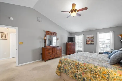 a bedroom with a bed dresser and a window