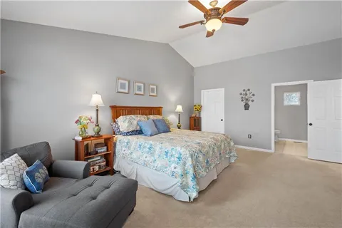 a bedroom with bed and a couch