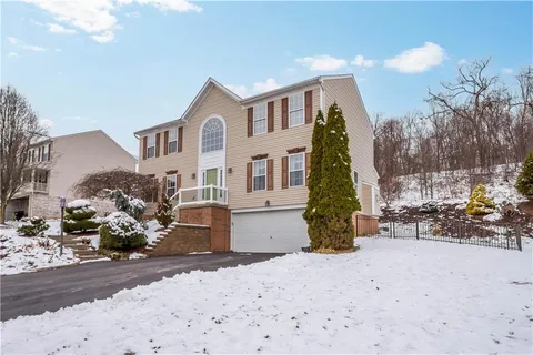 a view of a house with snow on the road