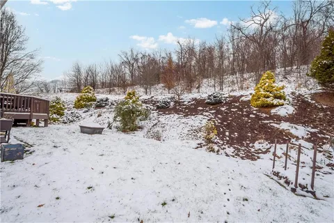 a view of a yard with snow on both side of the road