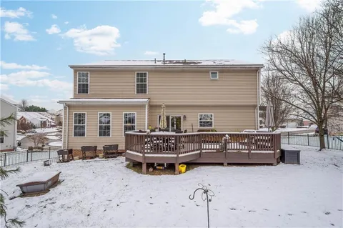 a view of a house with a yard covered in snow