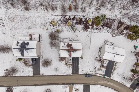 an aerial view of residential houses with outdoor space