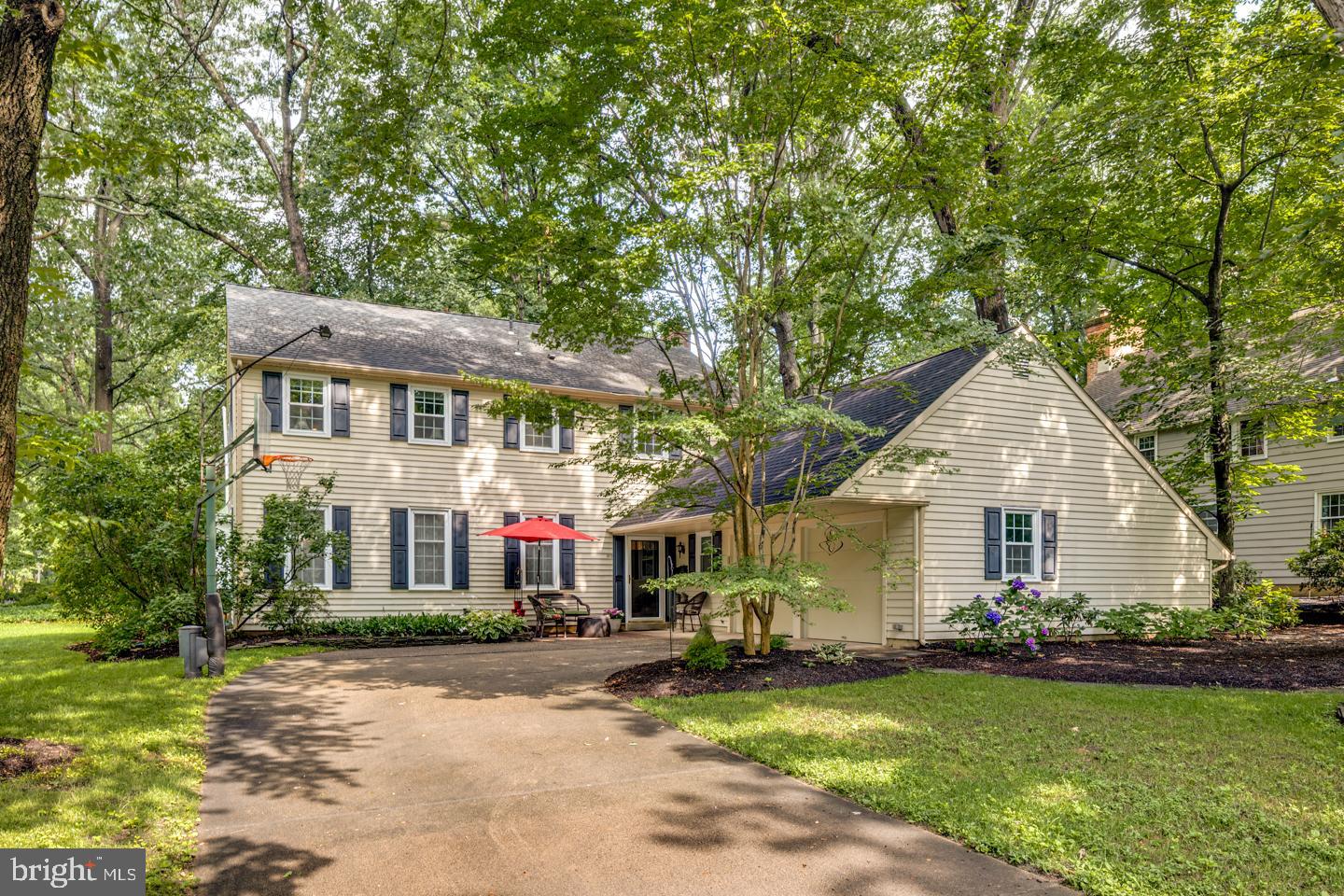 a front view of a house with yard and green space