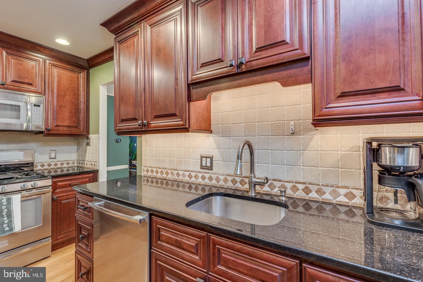 110 Wexford Drive Cherry Hill, NJ 08003 - Photo 13 of 51 a kitchen with stainless steel appliances granite countertop a sink stove and cabinets