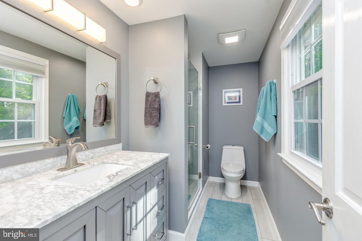 110 Wexford Drive Cherry Hill, NJ 08003 - Photo 39 of 51 a bathroom with a granite countertop sink a toilet and a window