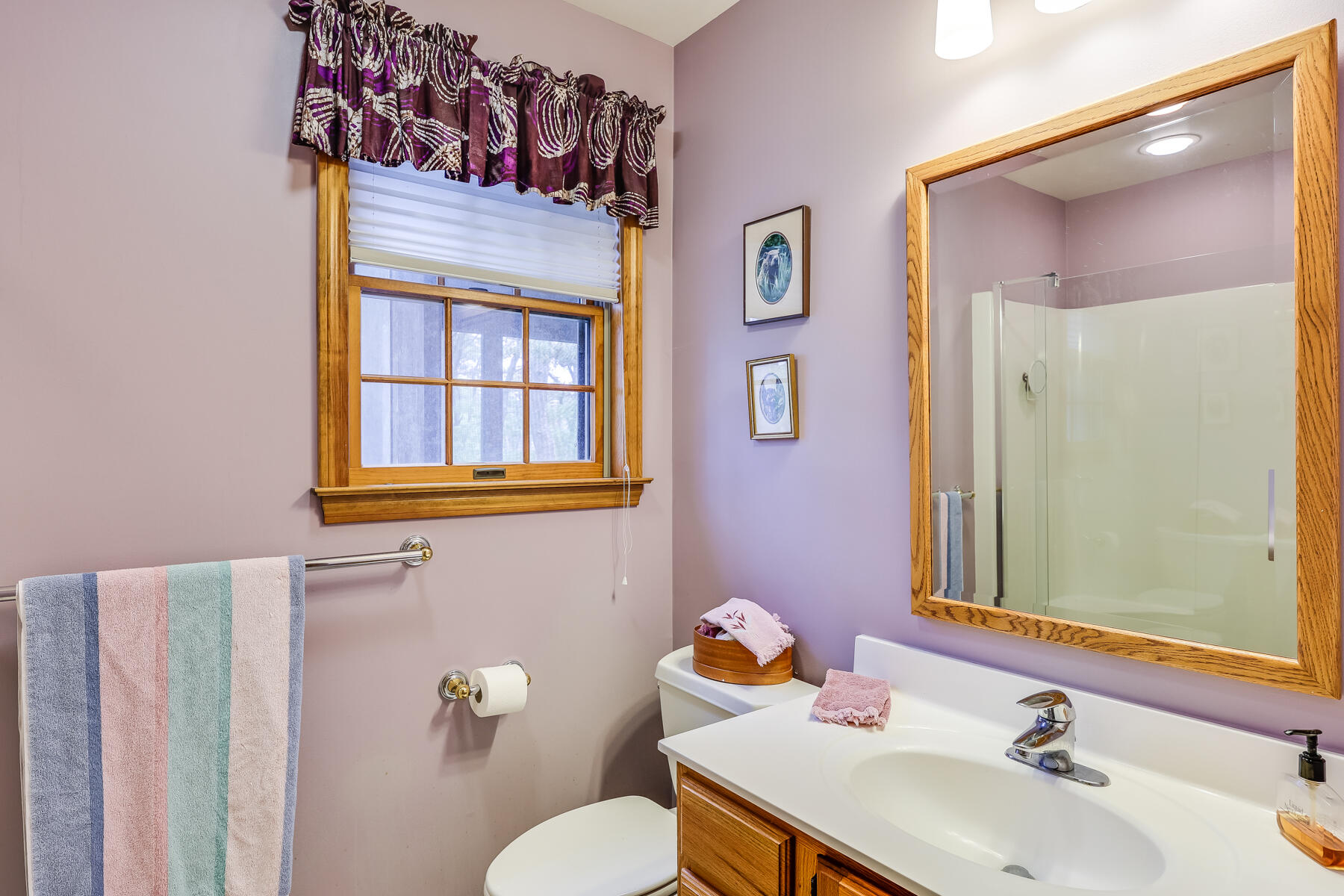 375 Eastwind Circle Wellfleet, MA 02667 - Photo 24 of 59 a bathroom with a sink mirror vanity and toilet