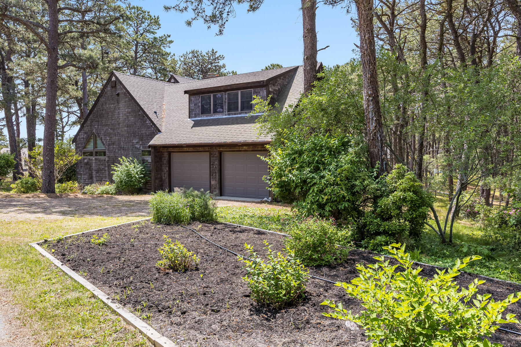 375 Eastwind Circle Wellfleet, MA 02667 - Photo 48 of 59 a view of a house with a tree in the background