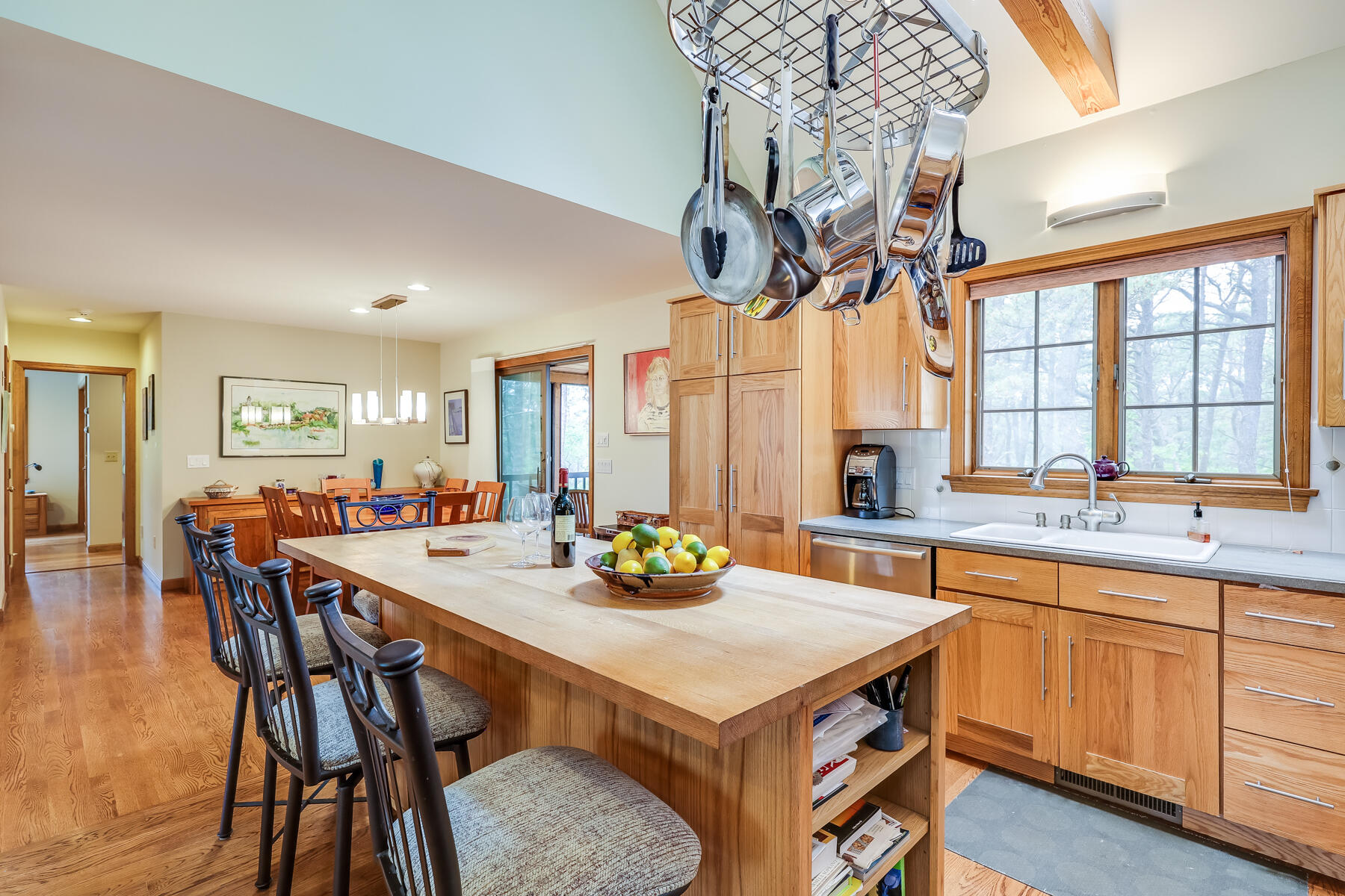 375 Eastwind Circle Wellfleet, MA 02667 - Photo 8 of 59 a kitchen with a table chairs and a chandelier