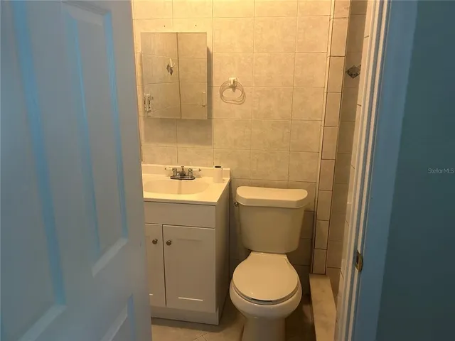 a white toilet sitting next to a bathroom sink