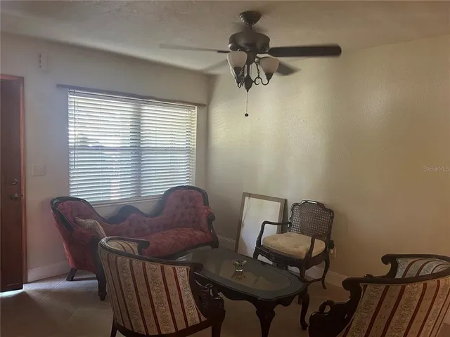 a view of an empty room with a fireplace and a window