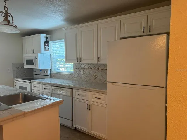 a room with table chairs and windows