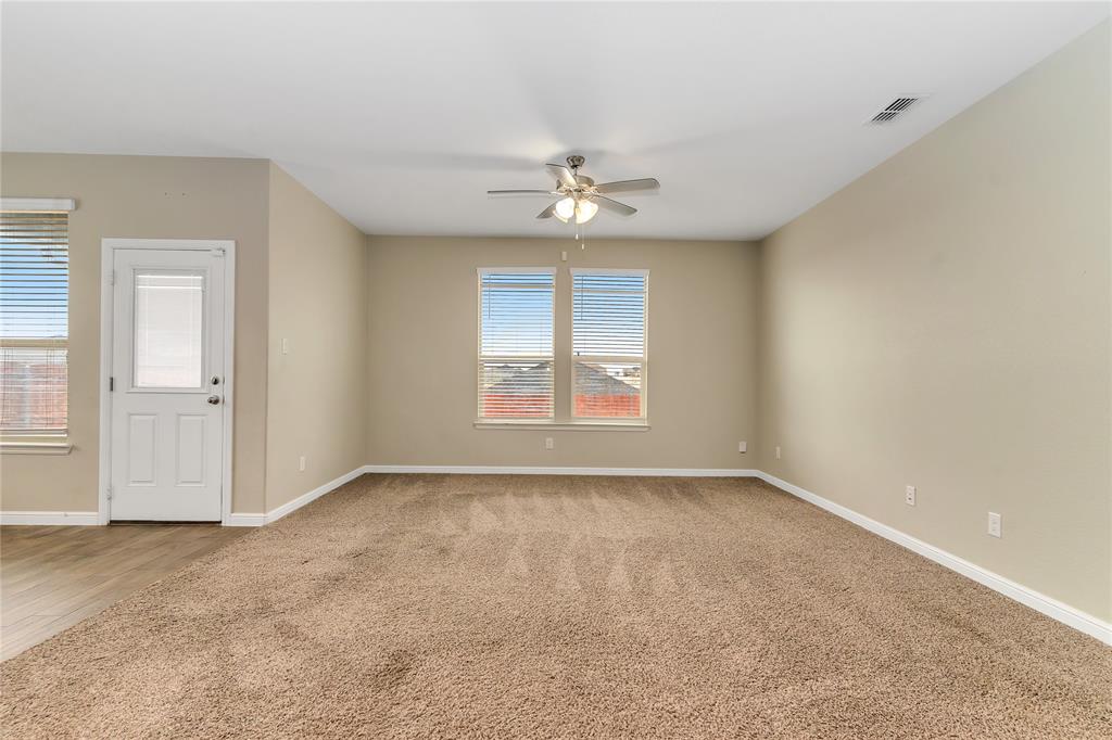 1102 Tiburon Trail Cleburne, TX 76033 - Photo 10 of 36 Empty room featuring light carpet and a ceiling fan