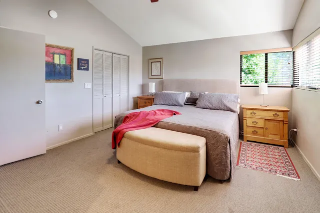 a bedroom with a bed and a table