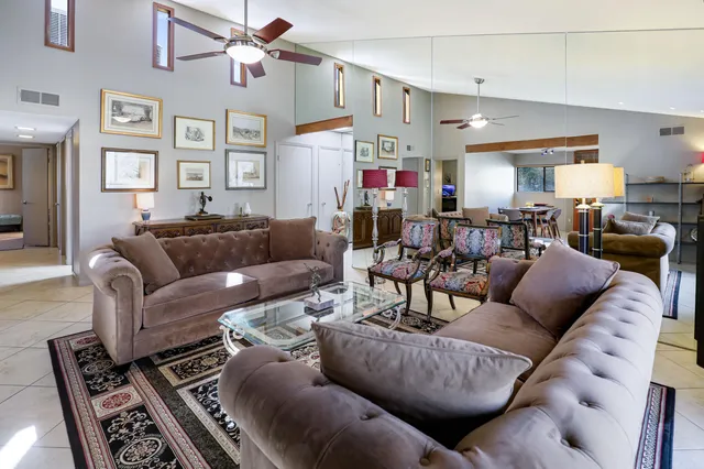a living room with furniture and a chandelier