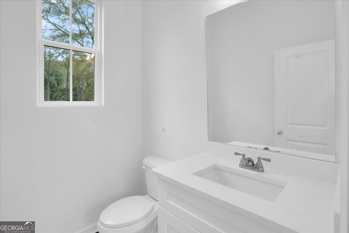 1397 Bridges Avenue Southwest Atlanta, GA 30310 - Photo 8 of 20 a white toilet sitting next to a bathroom sink