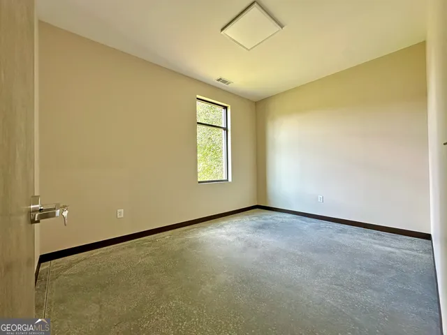 a view of a room with a table and chairs