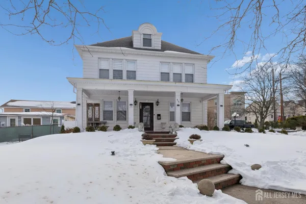 a living room with a large window and furniture