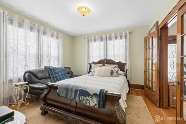 a view of a hallway with wooden floor and chandelier