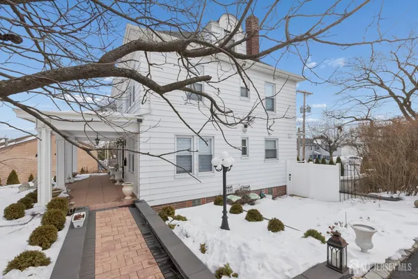 a view of an entryway with wooden floor fireplace and a window
