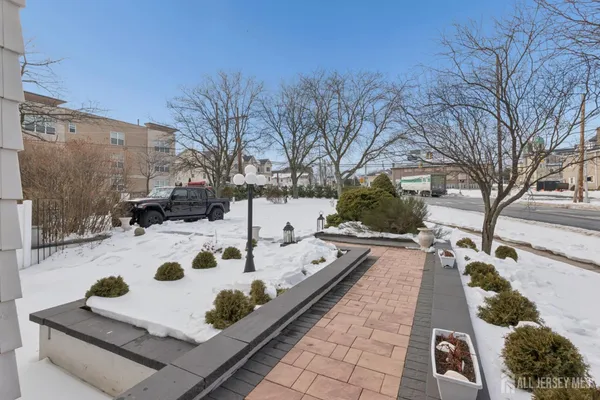 a view of a livingroom with wooden floor and a fireplace