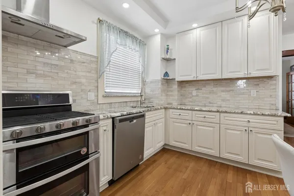 a bathroom with a granite countertop sink a toilet and shower