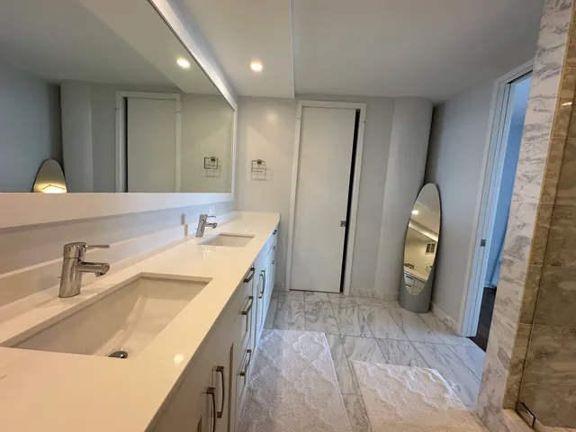a spacious bathroom with a sink and a mirror