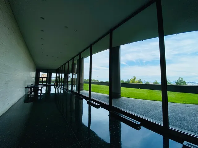 a view of an empty room with large windows and a table