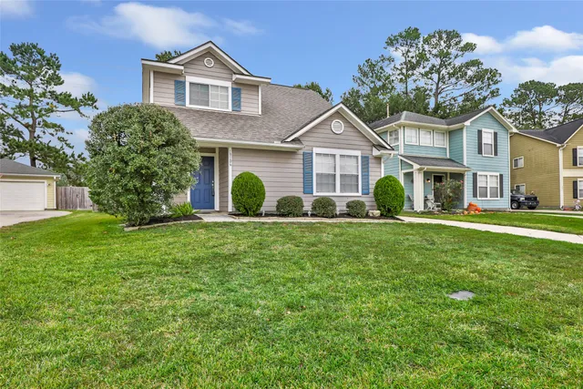 a front view of a house with a garden