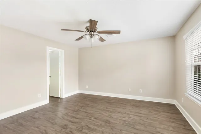 a view of room with hardwood floor and window