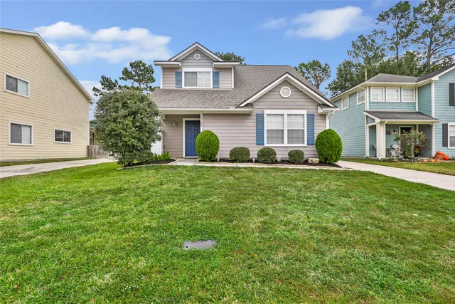 a front view of a house with garden and porch