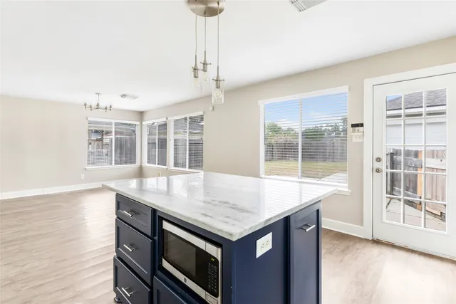 a kitchen with a stove a sink and a large window