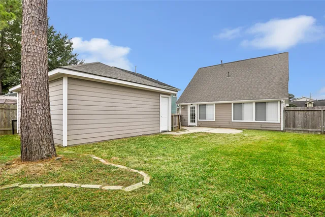 a backyard of a house with table and chairs