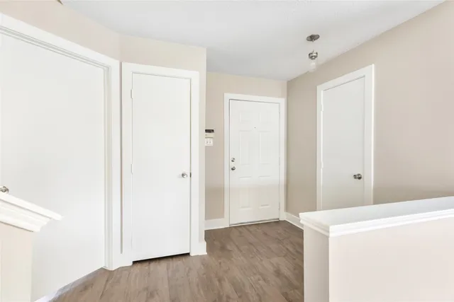 a view of hallway with wooden floor